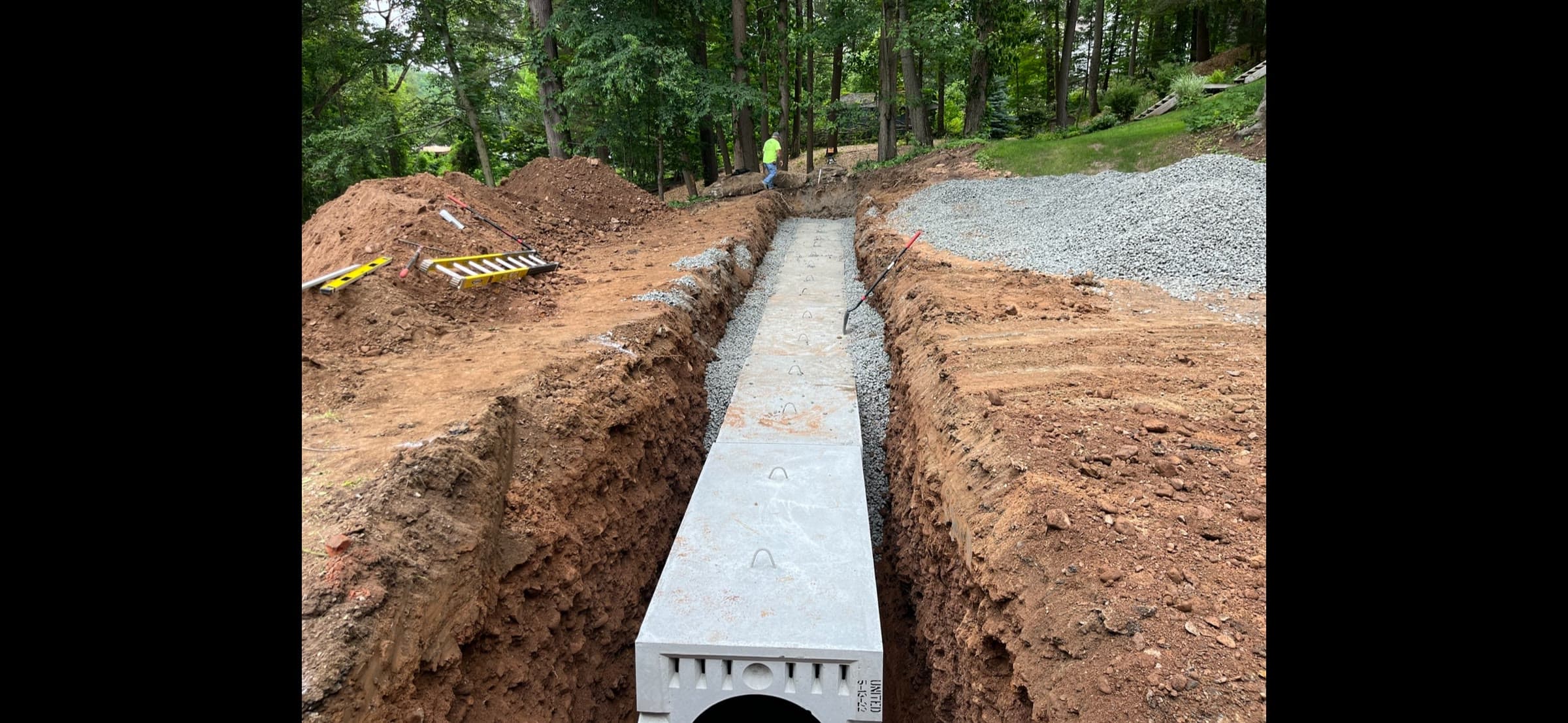 Concrete gallery septic leaching system set in a gravel trench.