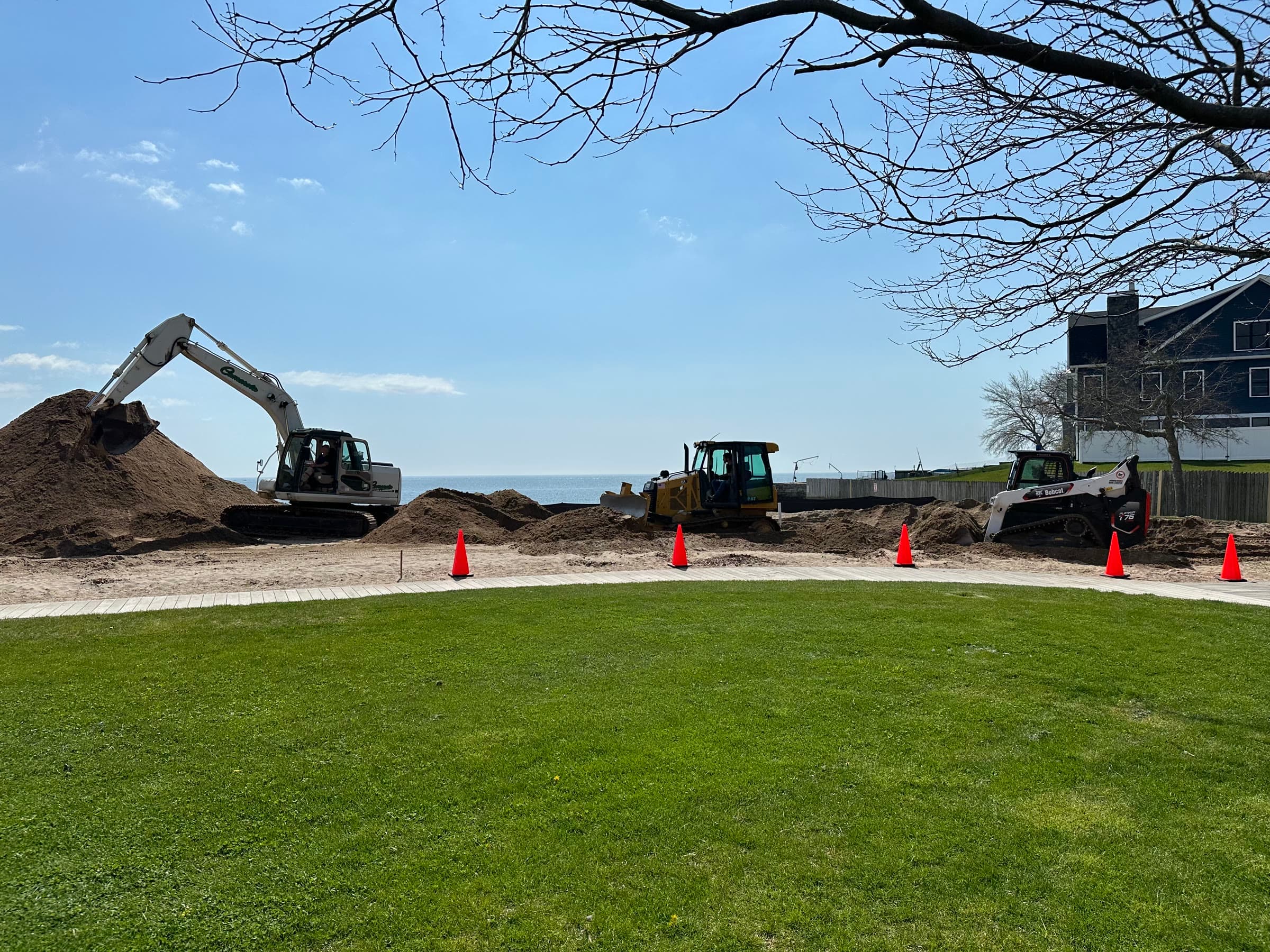 Camarota excavator, dozer, and skid steer on a waterfront Shoreline lot.